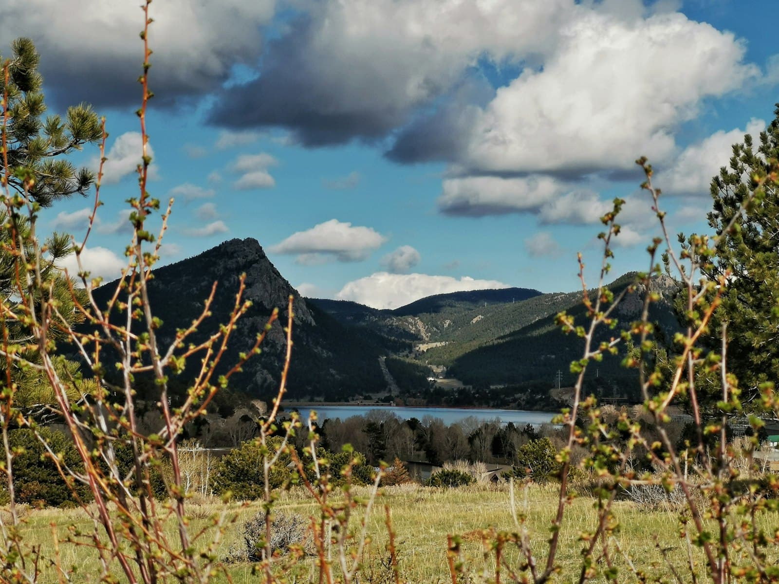 Estes Park — a scenic view of a mountain range with a lake in the distance