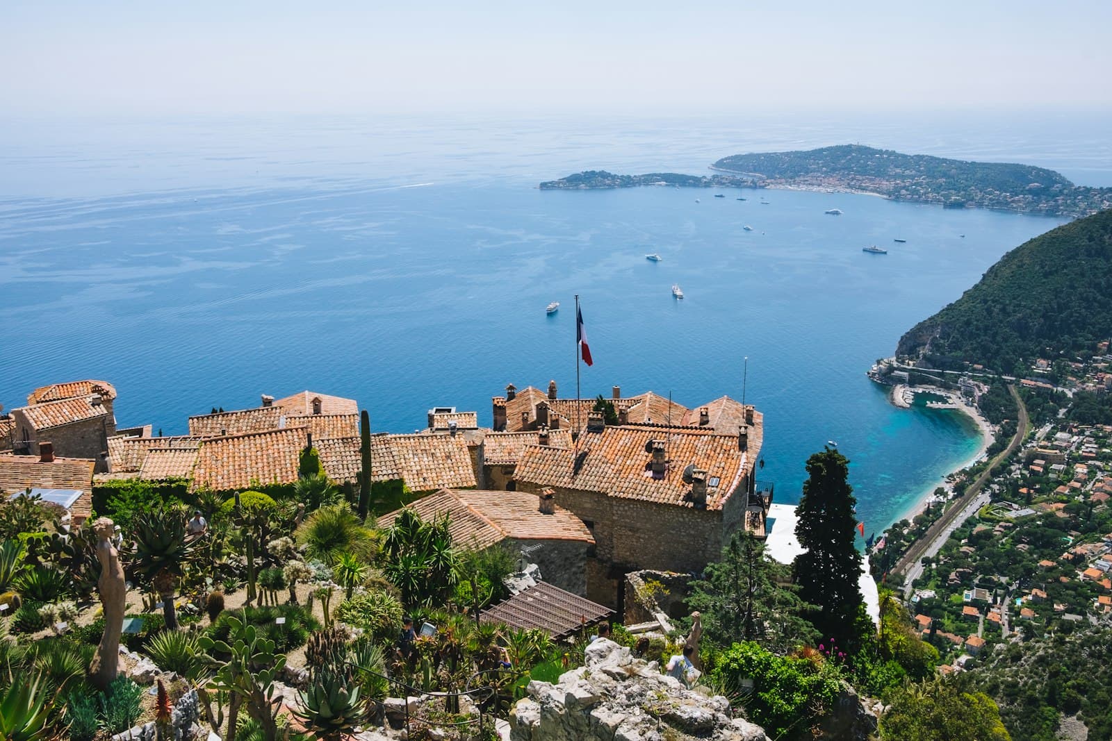 Èze — a castle overlooking a body of water surrounded by trees