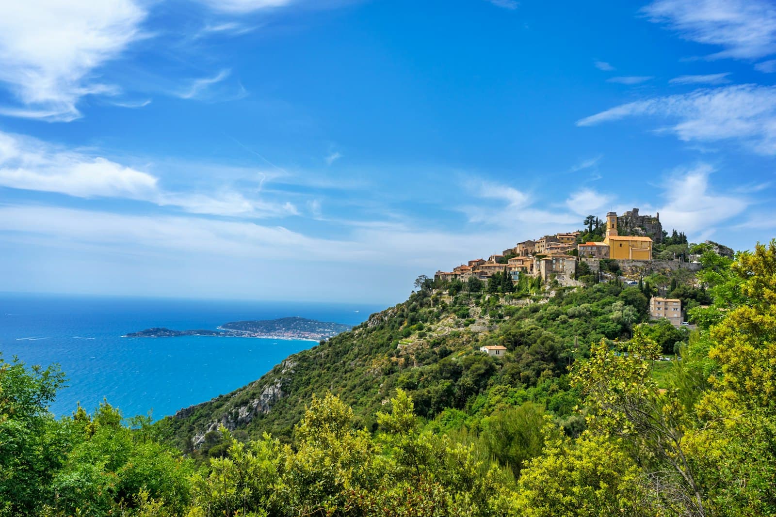 Èze — green trees on mountain near body of water during daytime