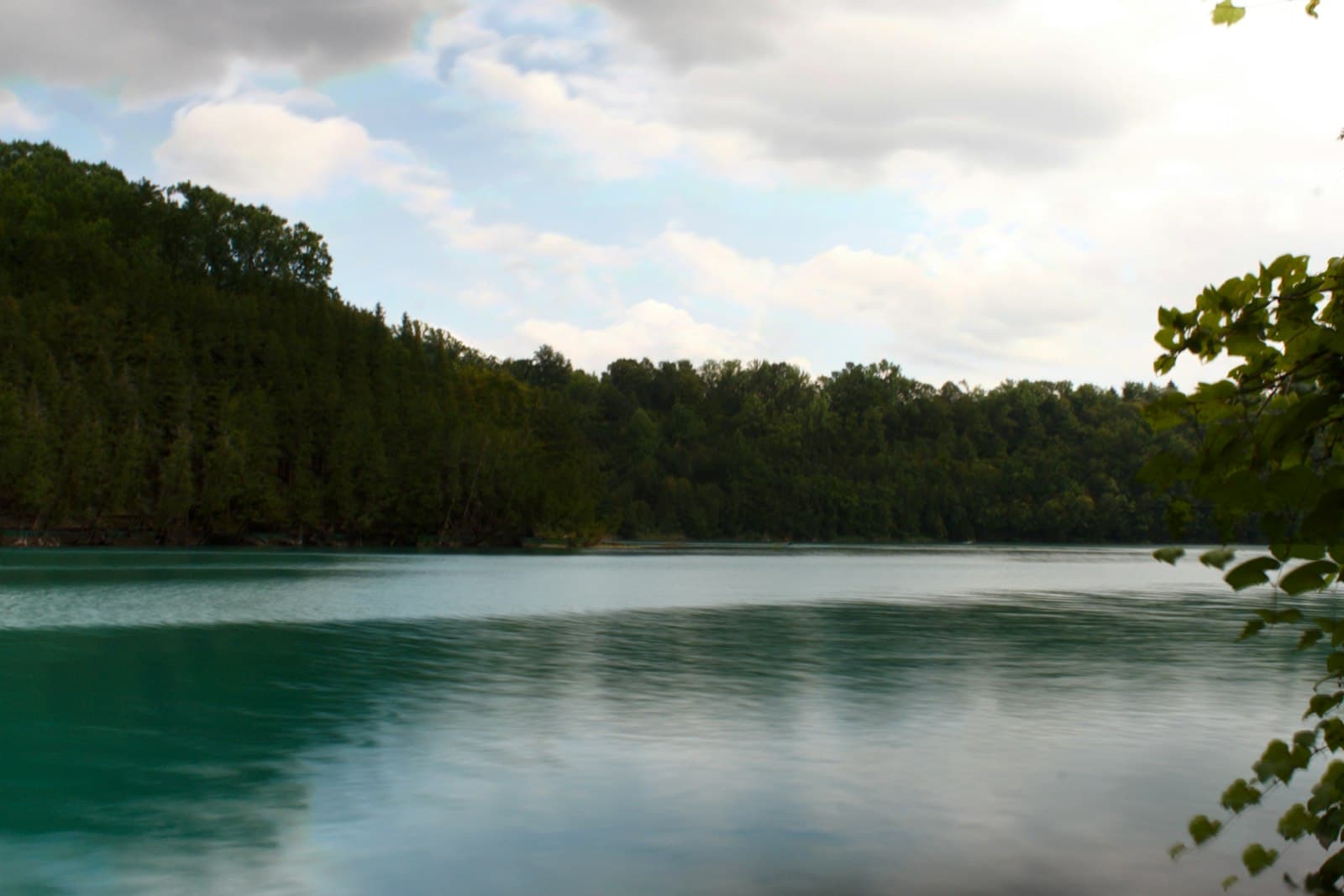 Fayetteville — A tranquil lake lies beside a dense forest.