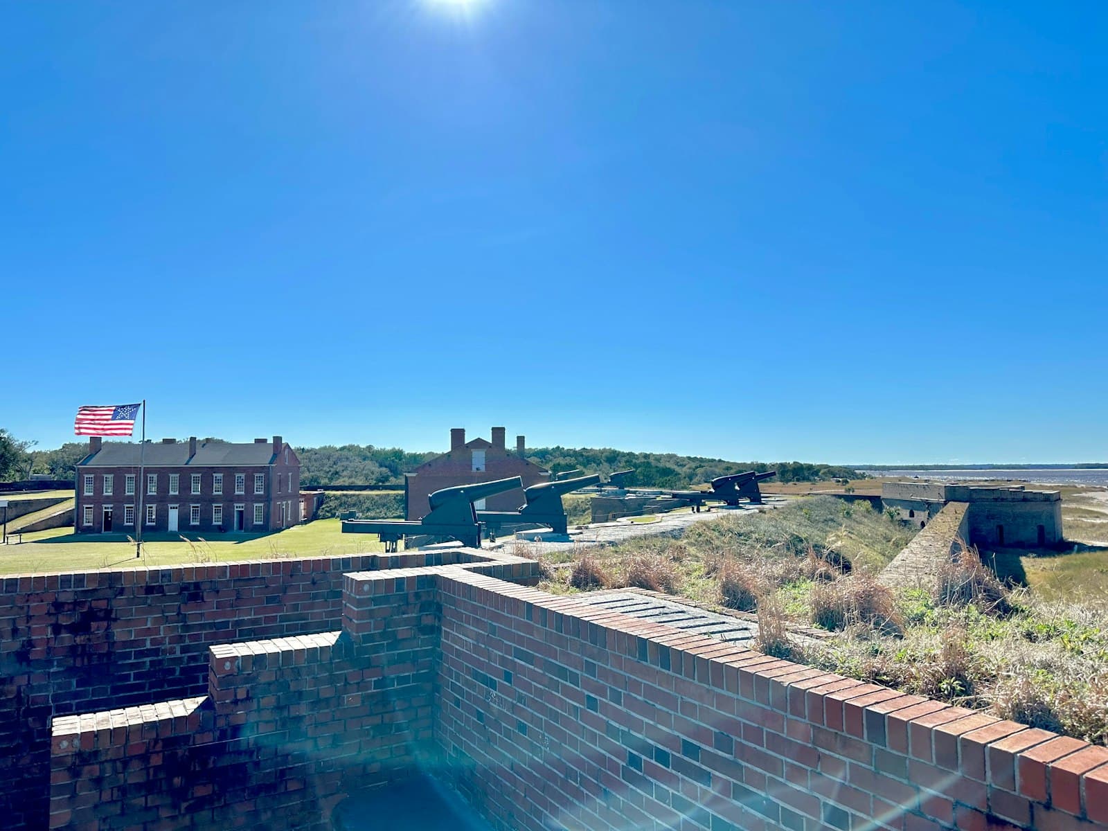 Fernandina Beach — a brick wall with a flag on top of it