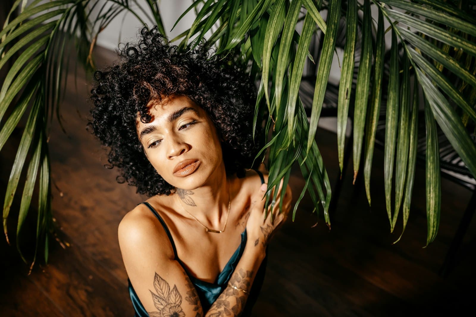 Ferndale — a woman with a tattoo on her arm leaning against a plant