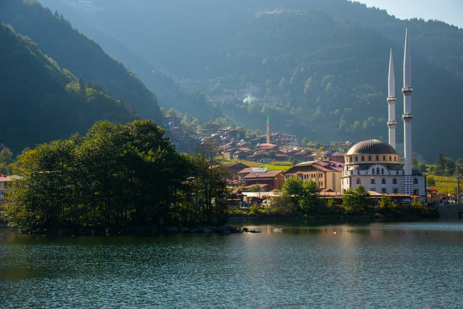 Fethiye — white and brown concrete building near green trees and lake during daytime