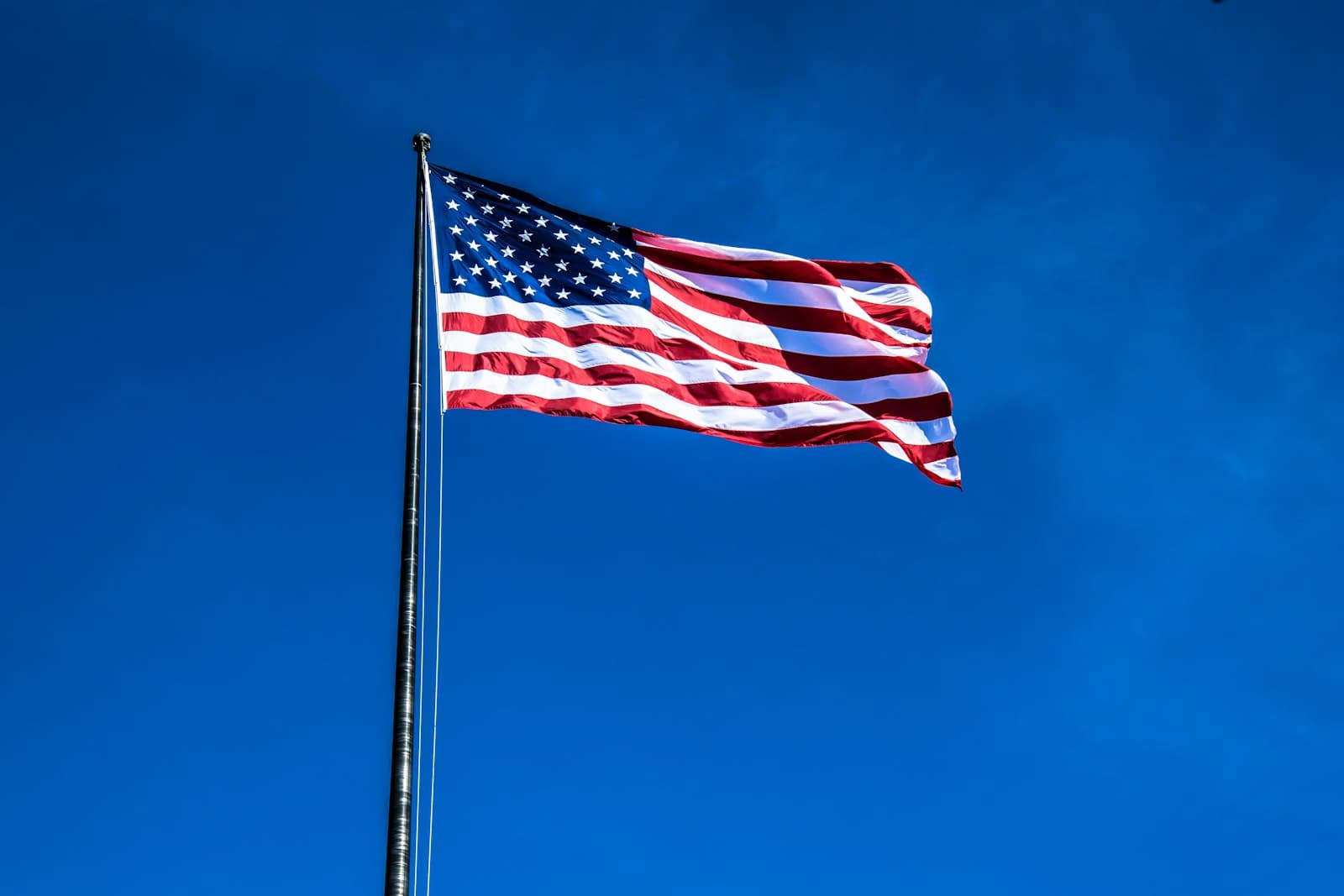 Flagstaff — a large american flag flying in the blue sky