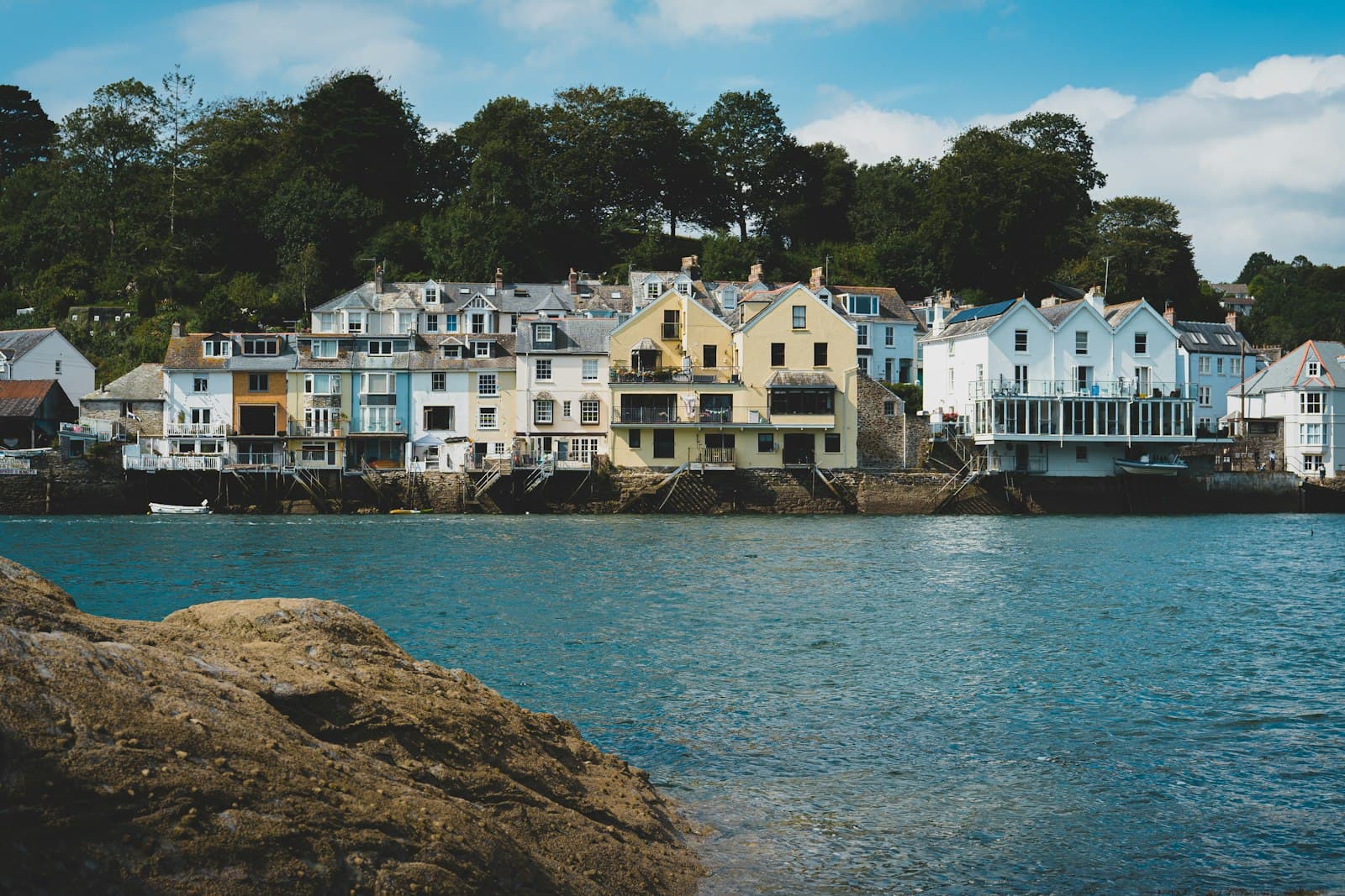 Fowey — white and brown concrete building near body of water during daytime