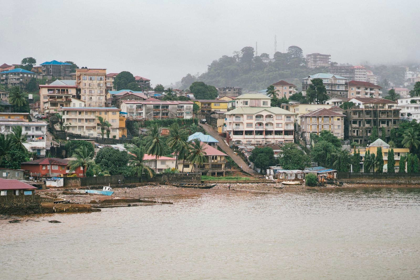 Freetown — brown and white concrete building near body of water during daytime