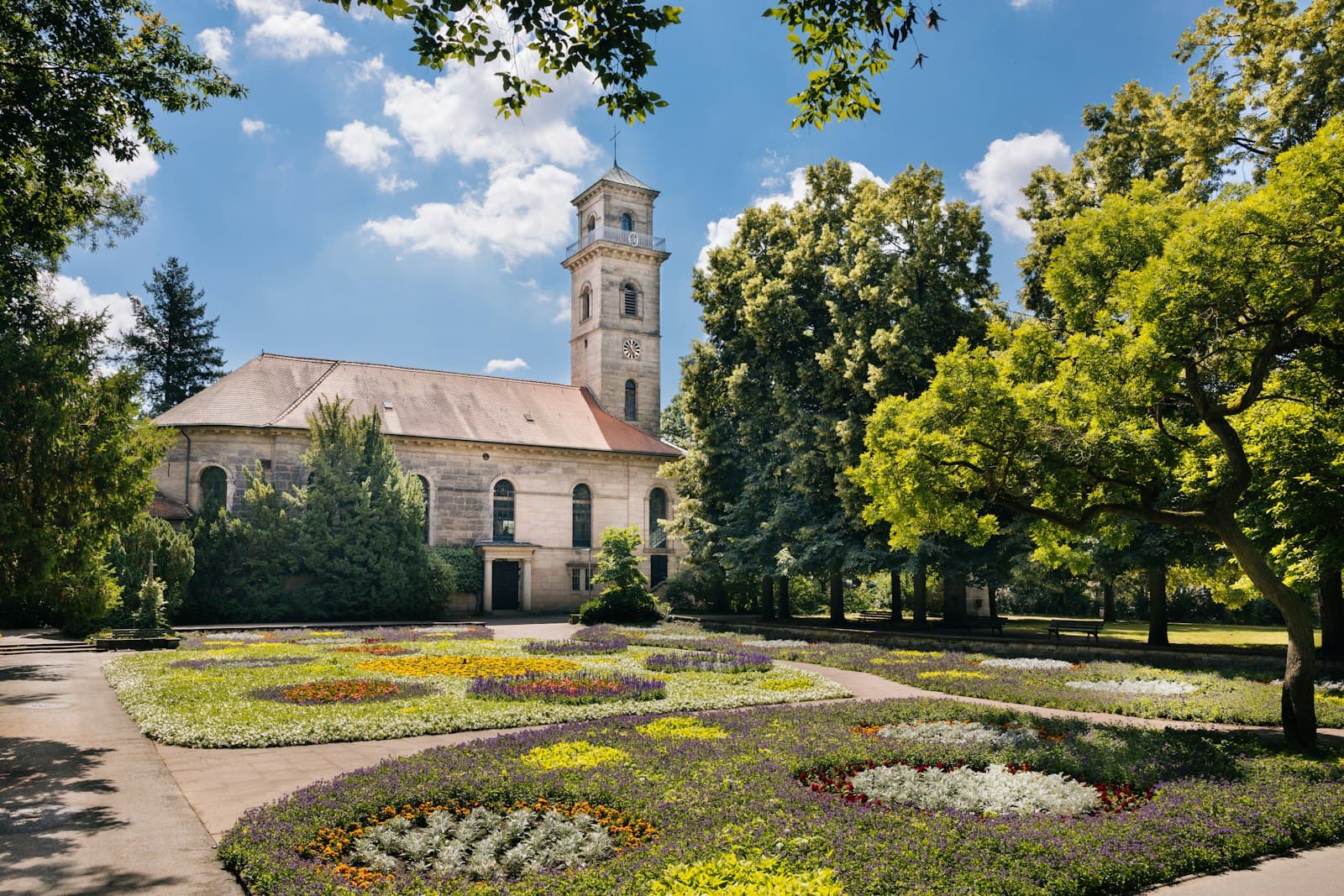 Fürth — A building with a clock tower in the middle of a garden