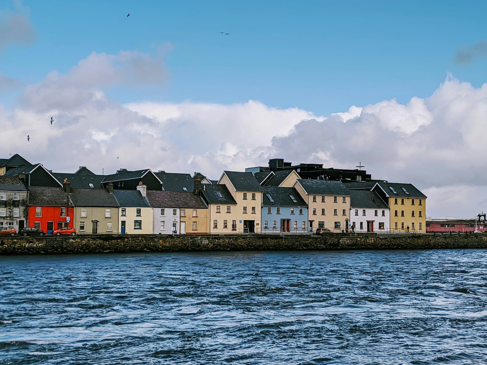 Galway — white and brown concrete building beside body of water during daytime