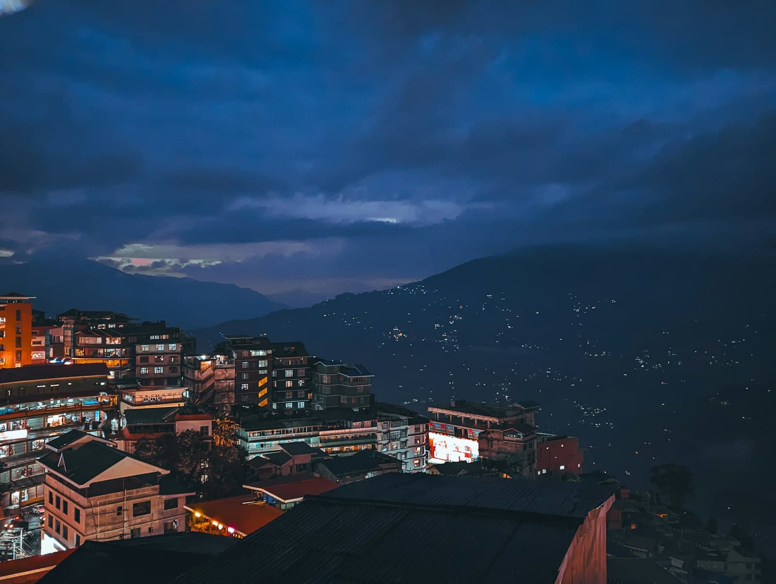 Gangtok — a view of a city at night from a hill