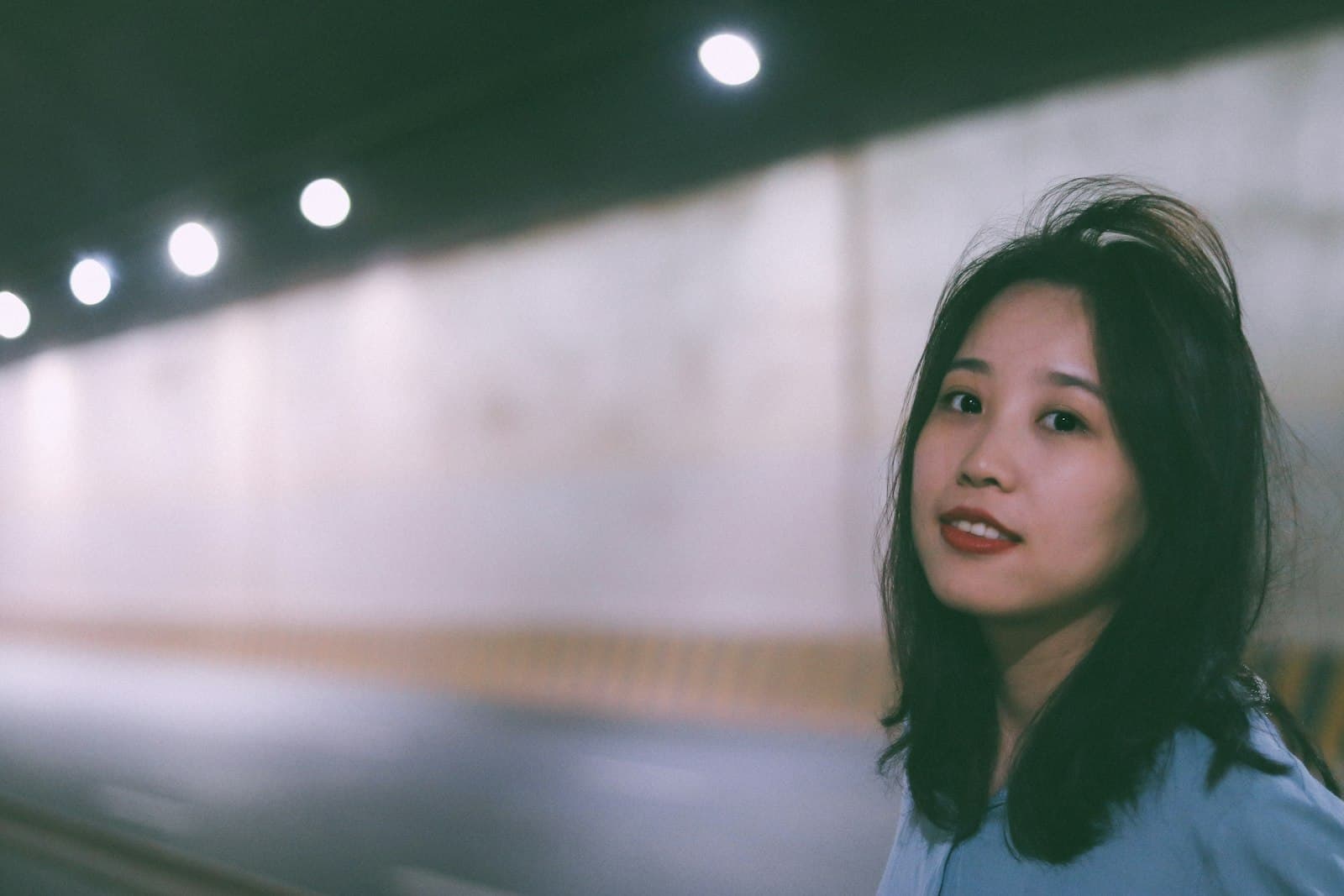 Ganzhou — a woman in a blue shirt standing in front of a wall