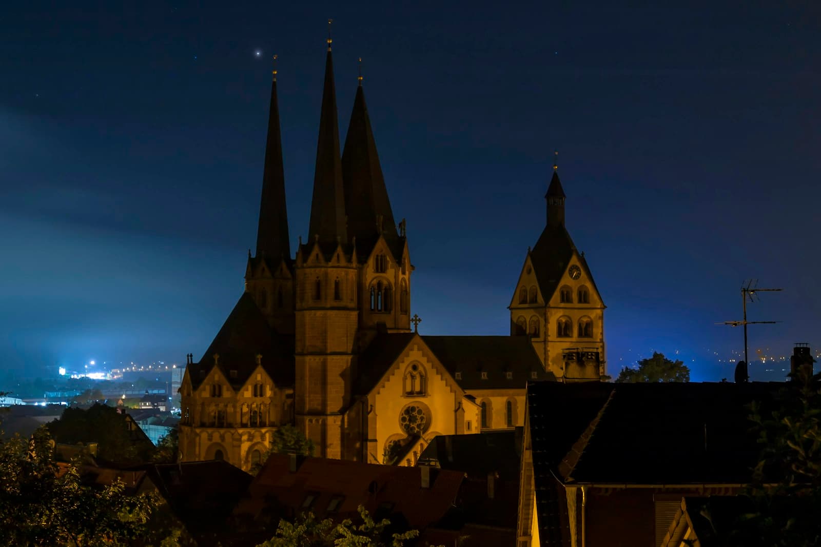 Gelnhausen — A church lit up at night with a city in the background