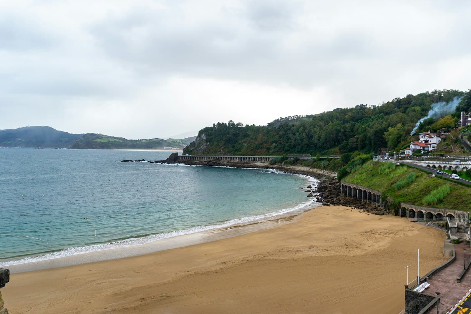Getaria — a view of a beach with a train on the tracks
