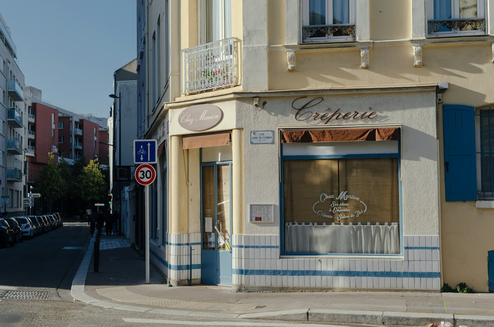 Gien — A street corner with cars parked on the side of it