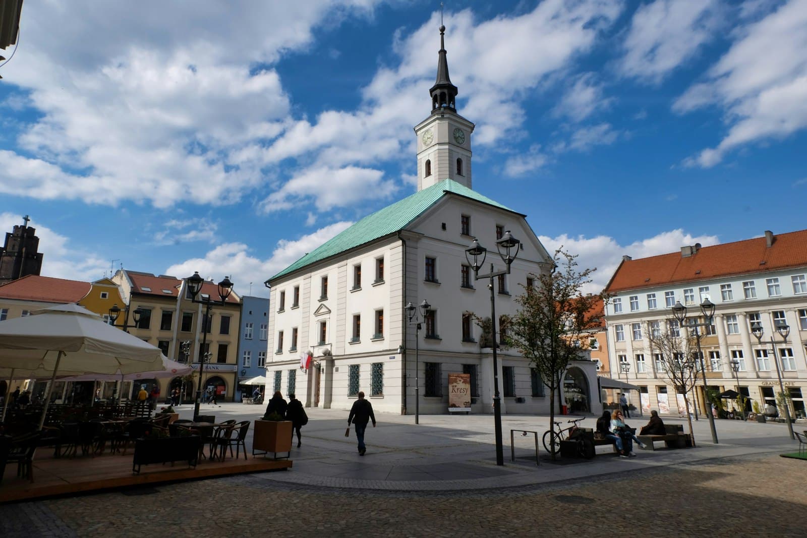 Gliwice — people walking near white and green concrete building during daytime