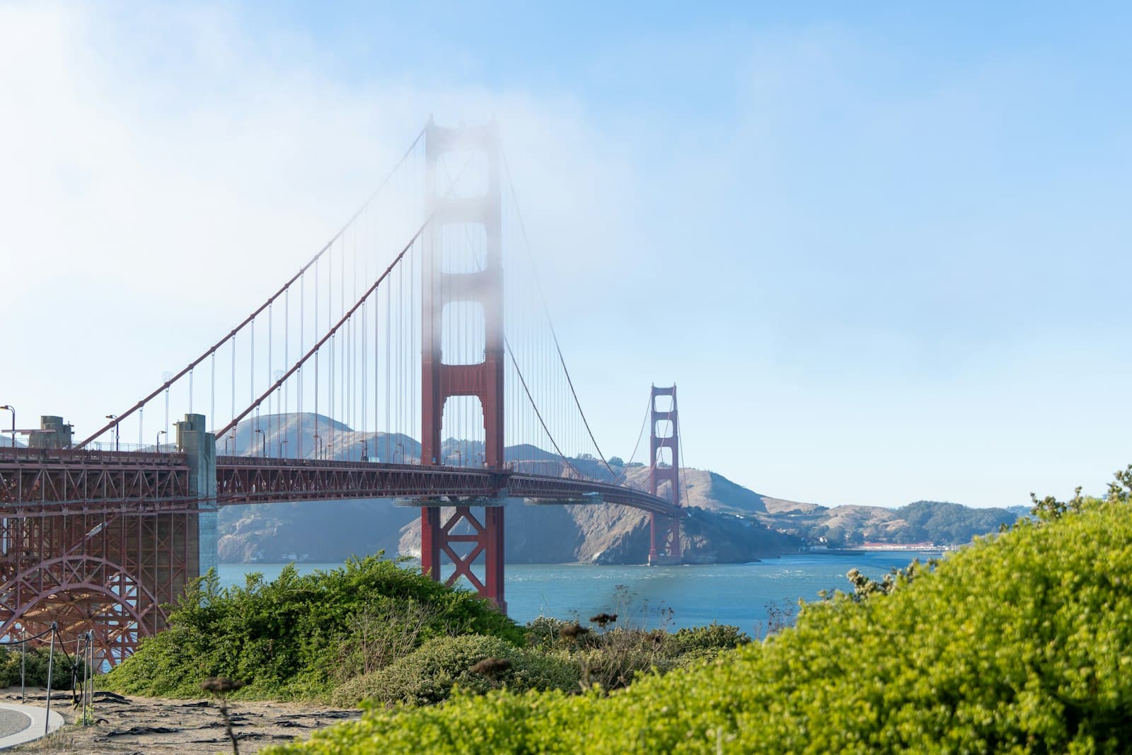 Golden — A view of the golden gate bridge from the side of a hill