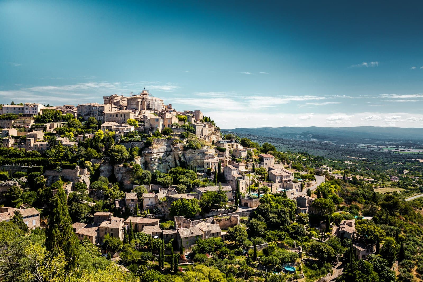 Gordes — a village on top of a hill surrounded by trees