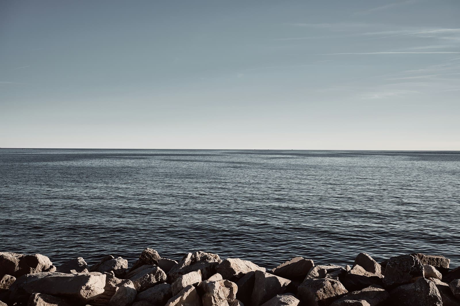 Grado — a rocky beach with water in the background