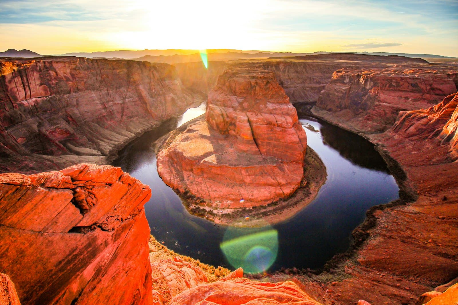Grand Junction — brown rock formation beside body of water during daytime