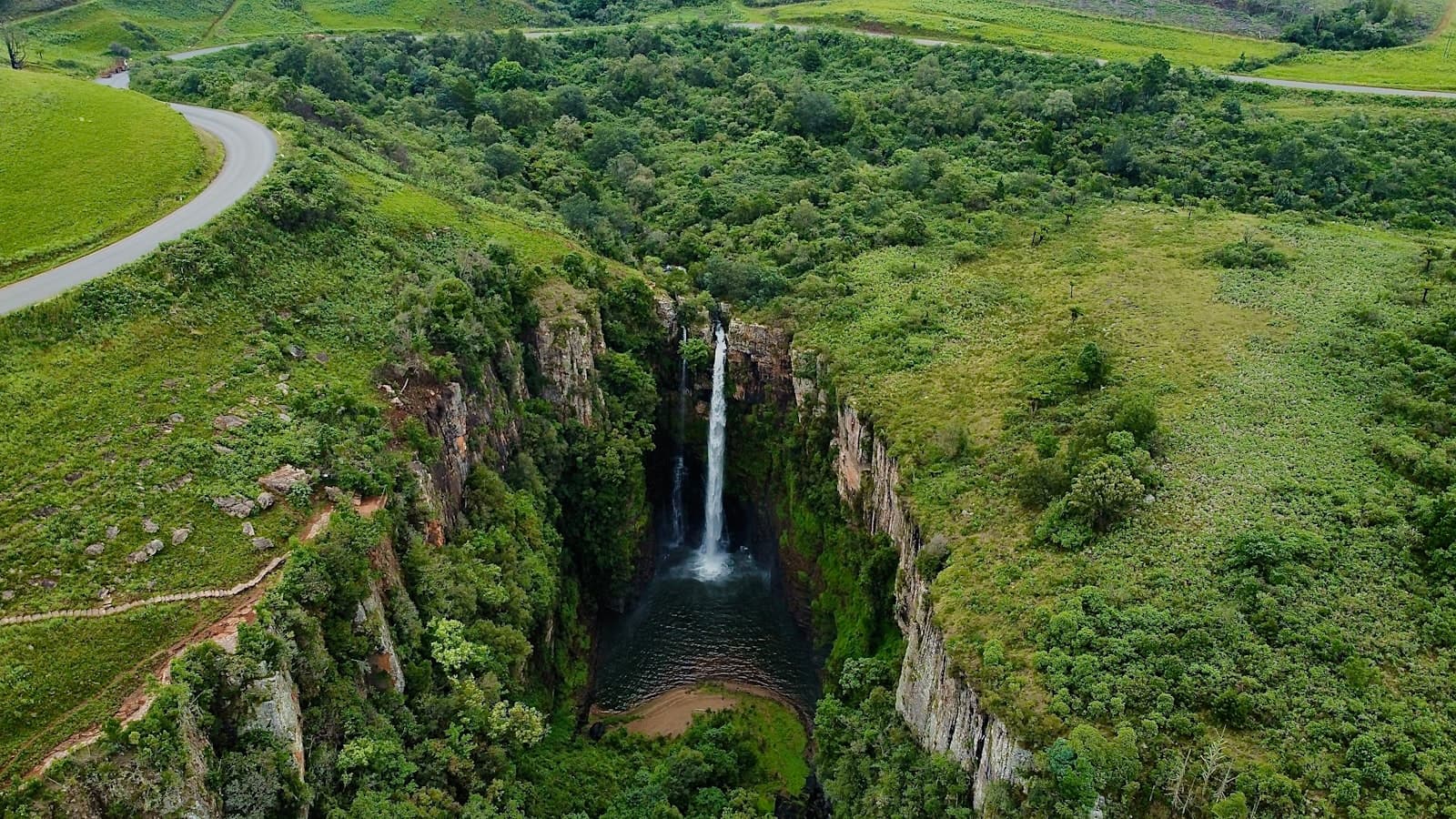 Graskop — a large waterfall in the middle of a lush green valley