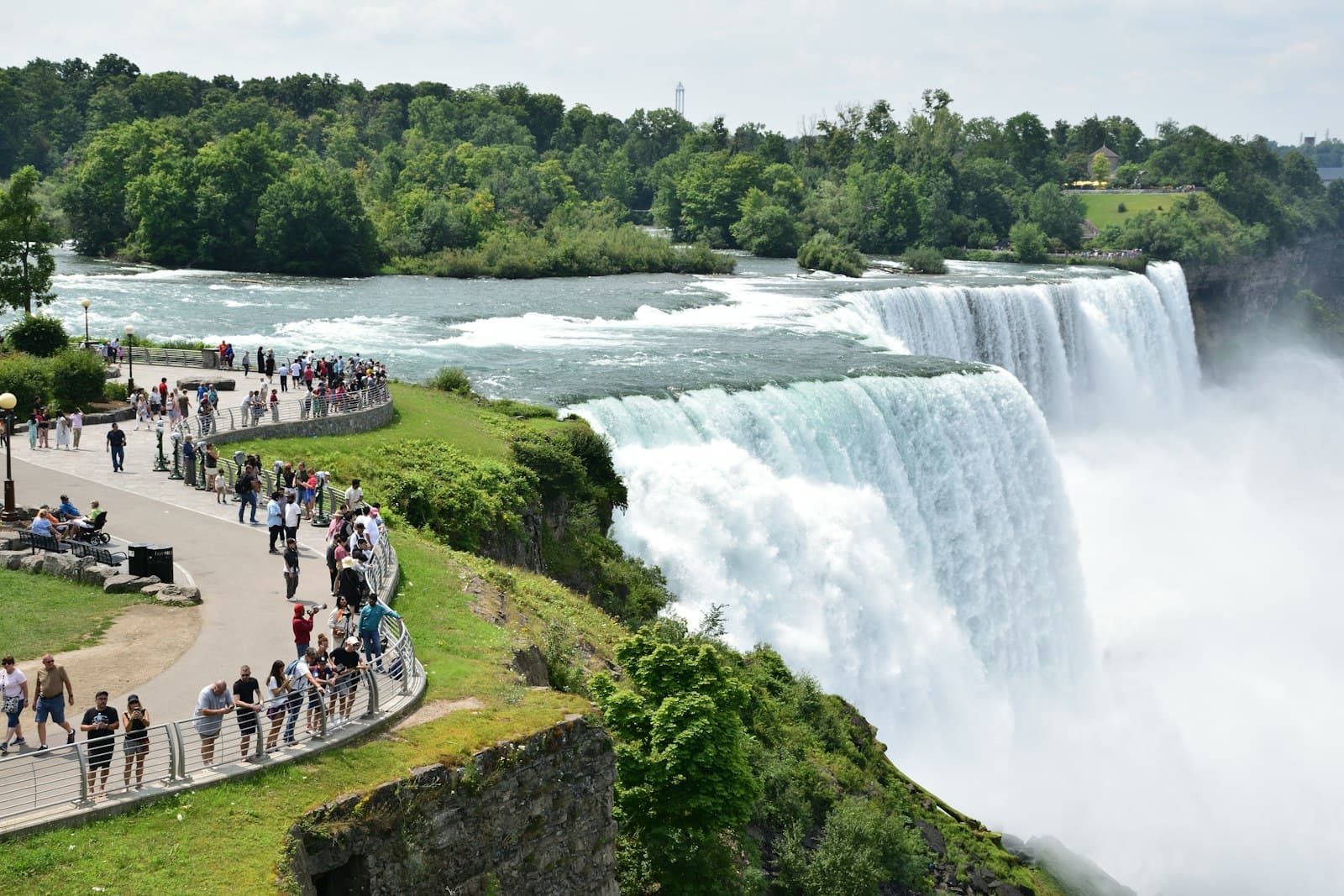 Great Falls — A group of people standing in front of a waterfall
