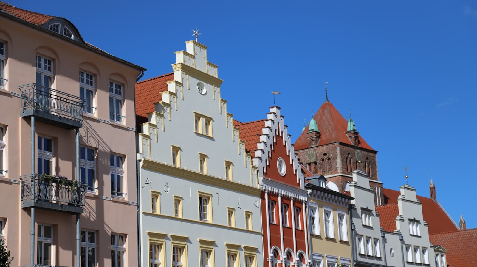 Greifswald — Row of colorful historic buildings under blue sky