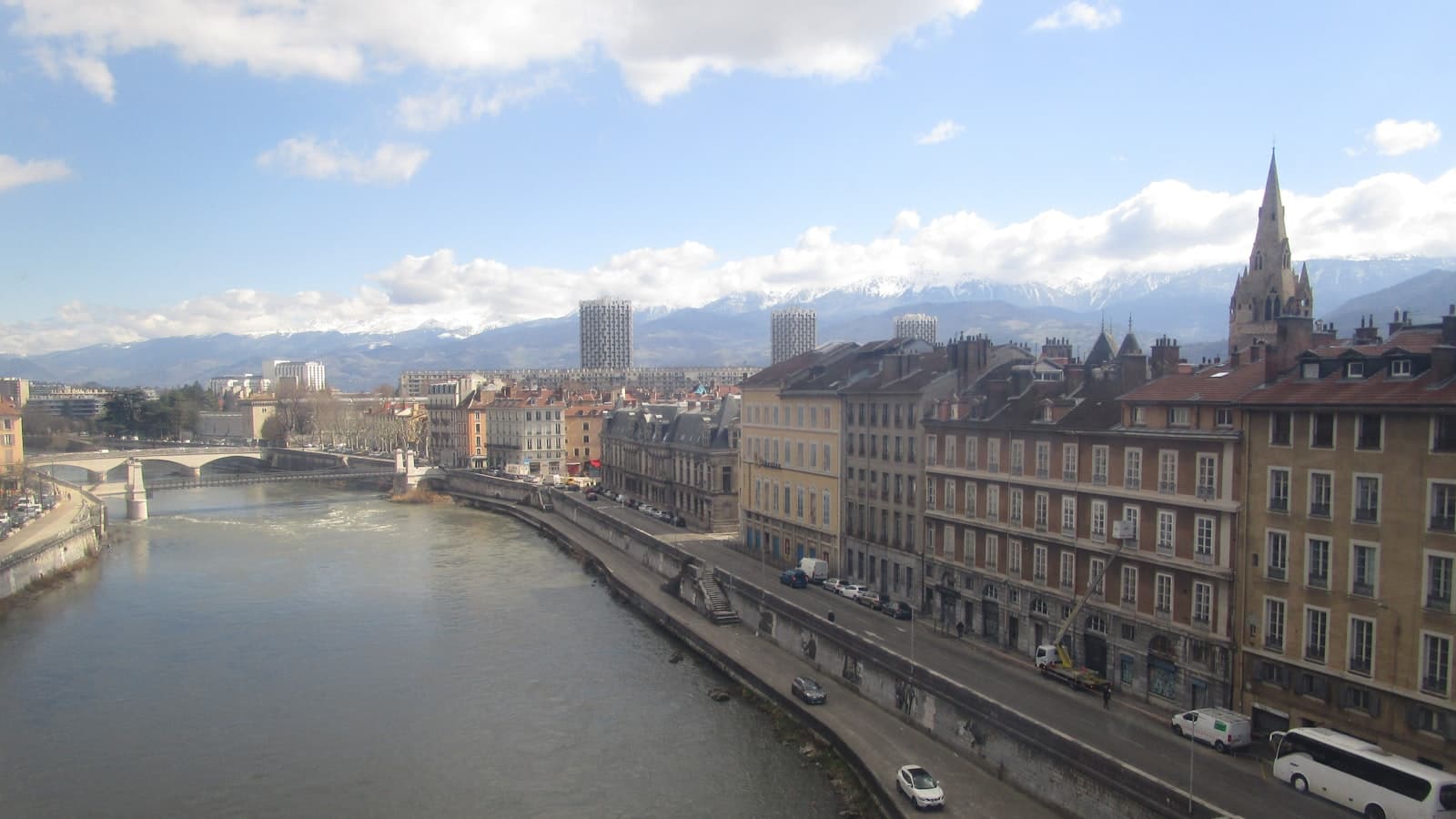 Grenoble — a river running through a city next to tall buildings