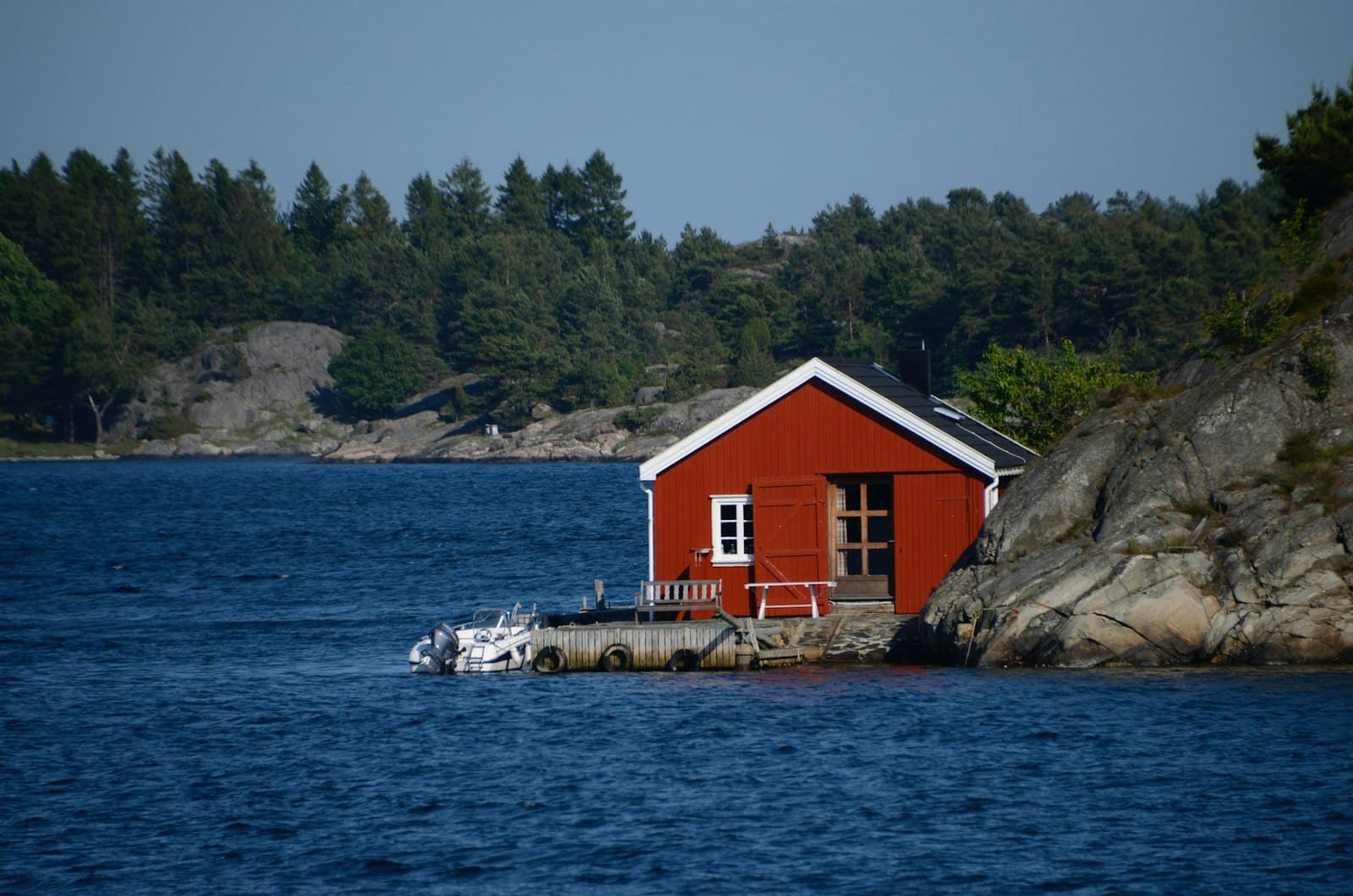 Grimstad — red and white house near body of water during daytime