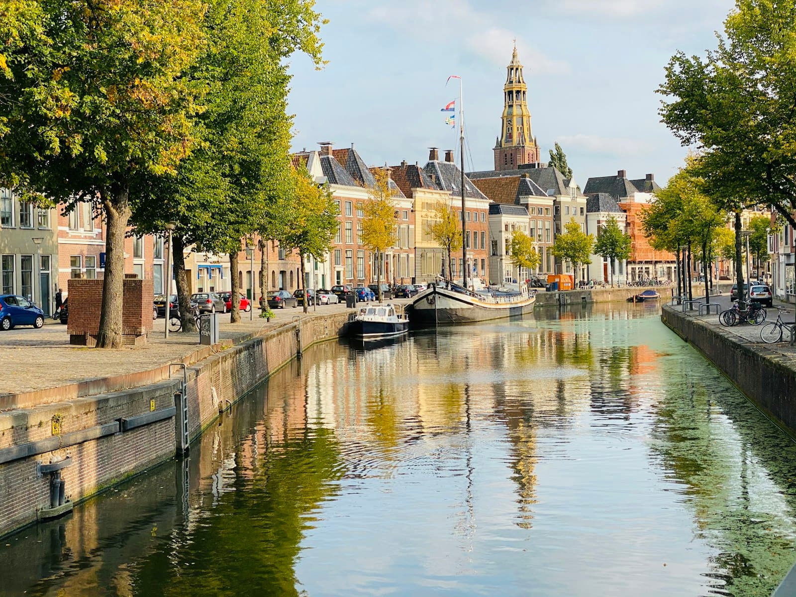 Groningen — boat on river near trees and buildings during daytime