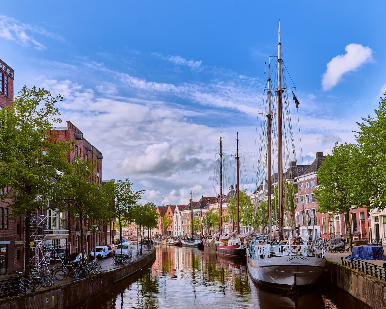 Groningen — white boat on river near buildings during daytime