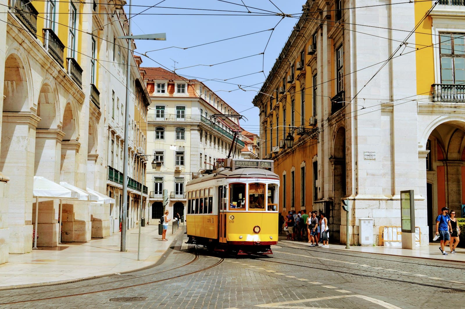 Guarda — yellow and white tram on road during daytime