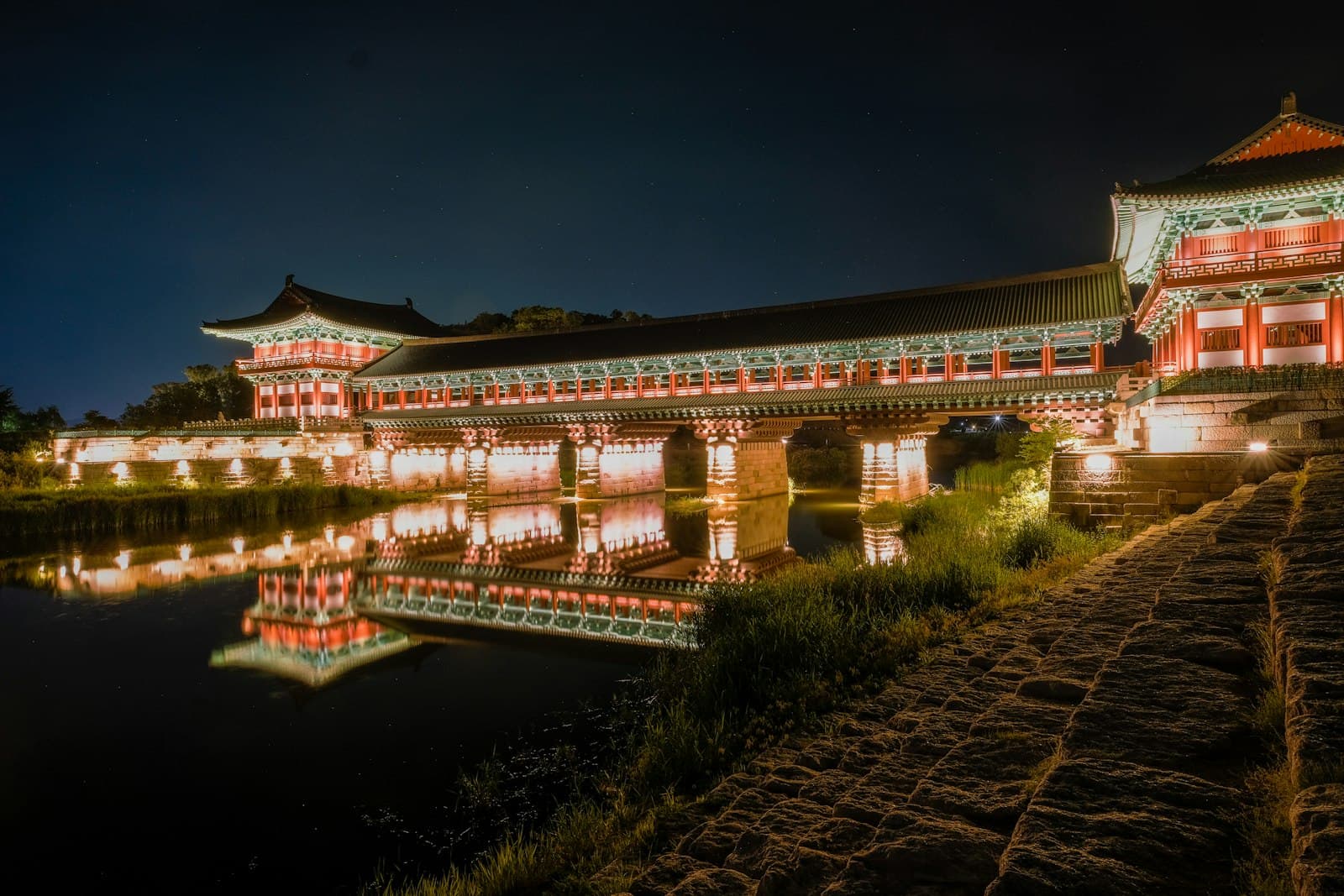 Gyeongju — a building lit up at night next to a body of water