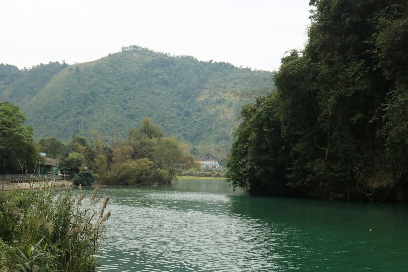 Hà Giang — a body of water surrounded by trees and mountains