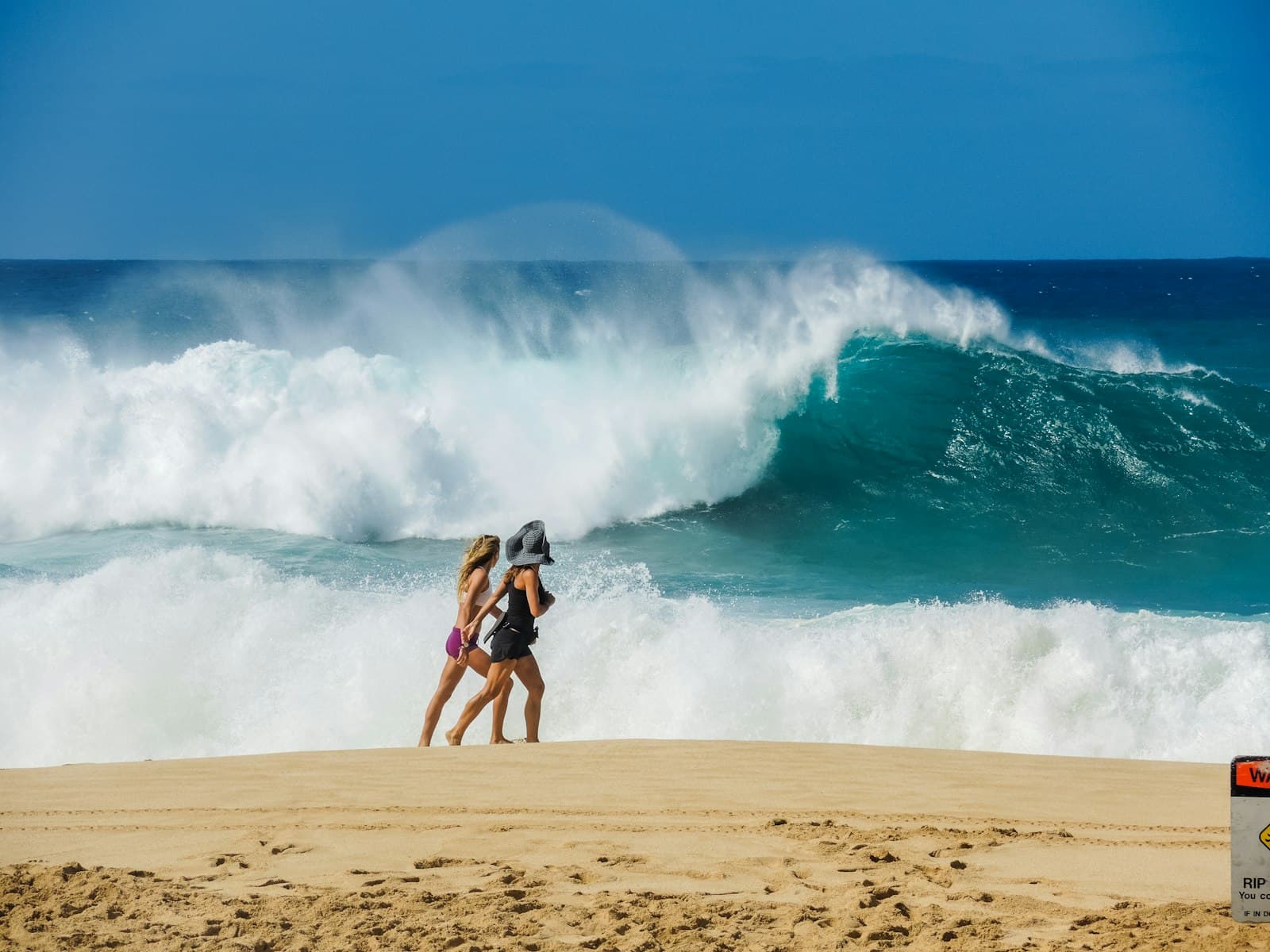 Haleiwa — two women walking on shore