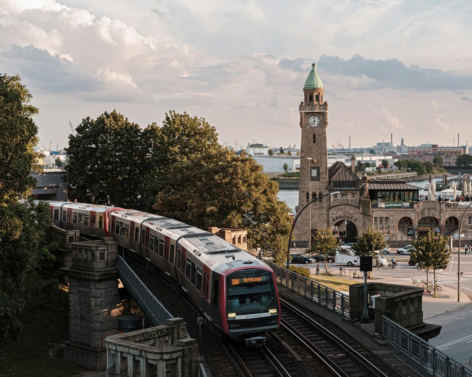 Hamburg — brown and white train on rail road near brown concrete building during daytime