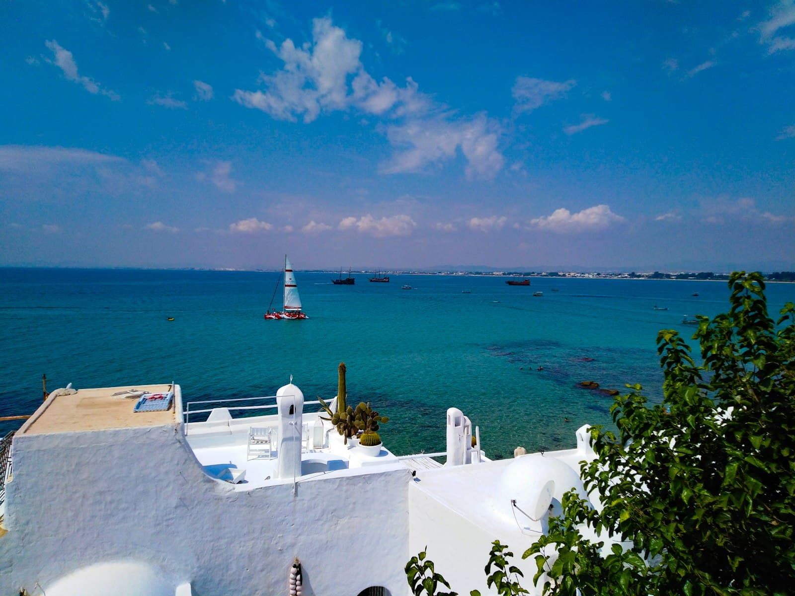 Hammamet — a view of a body of water with a lighthouse in the distance