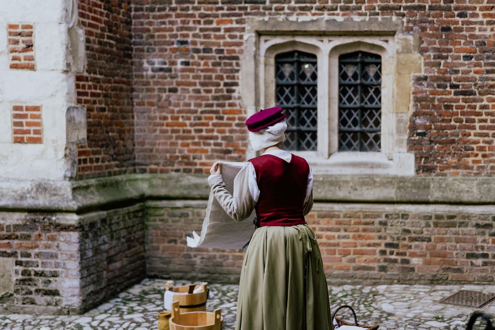 Hampton — woman doing laundry outside with brown buckets