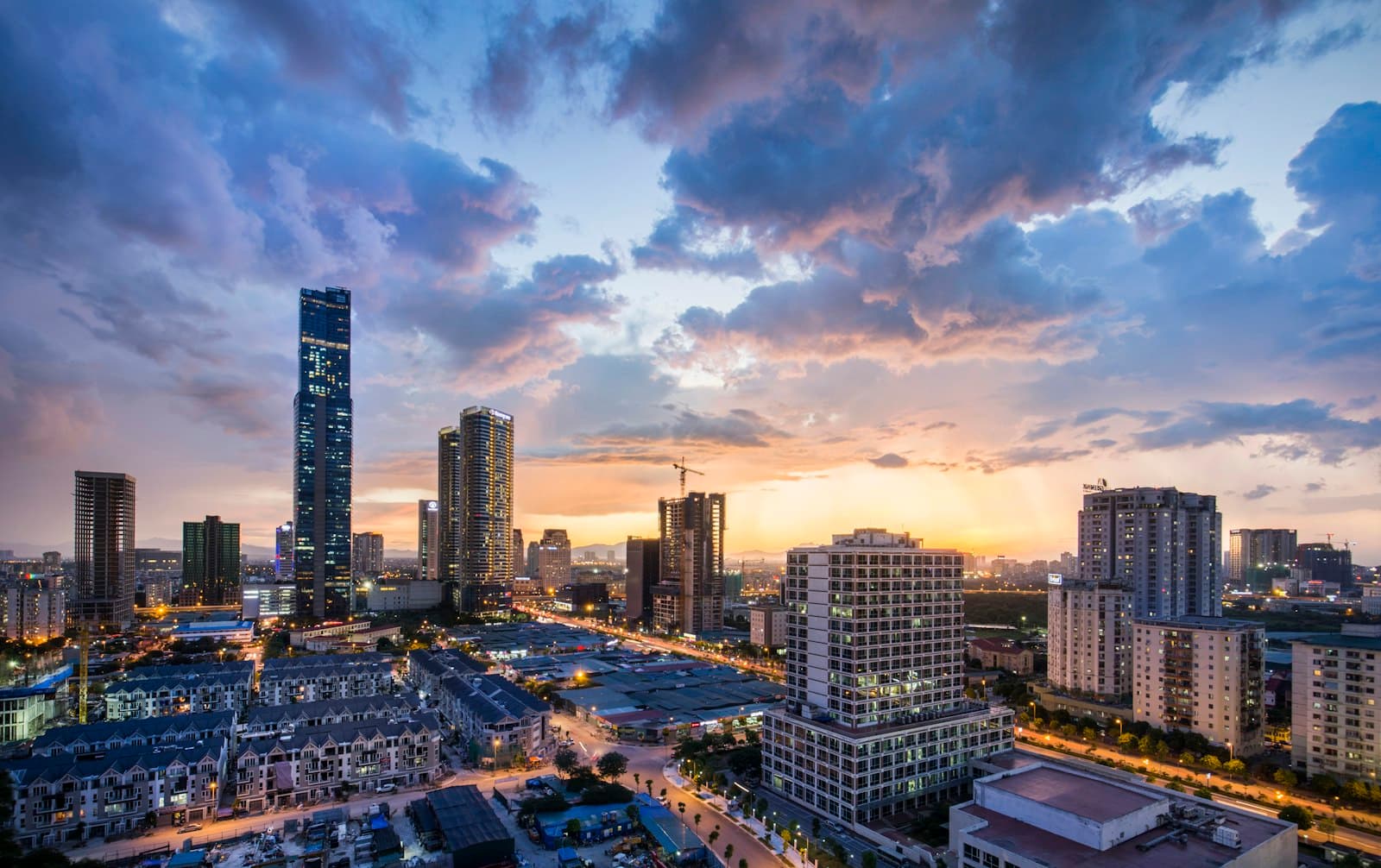Hanoi — gray high-rise buildings under gray clouds during golden hour