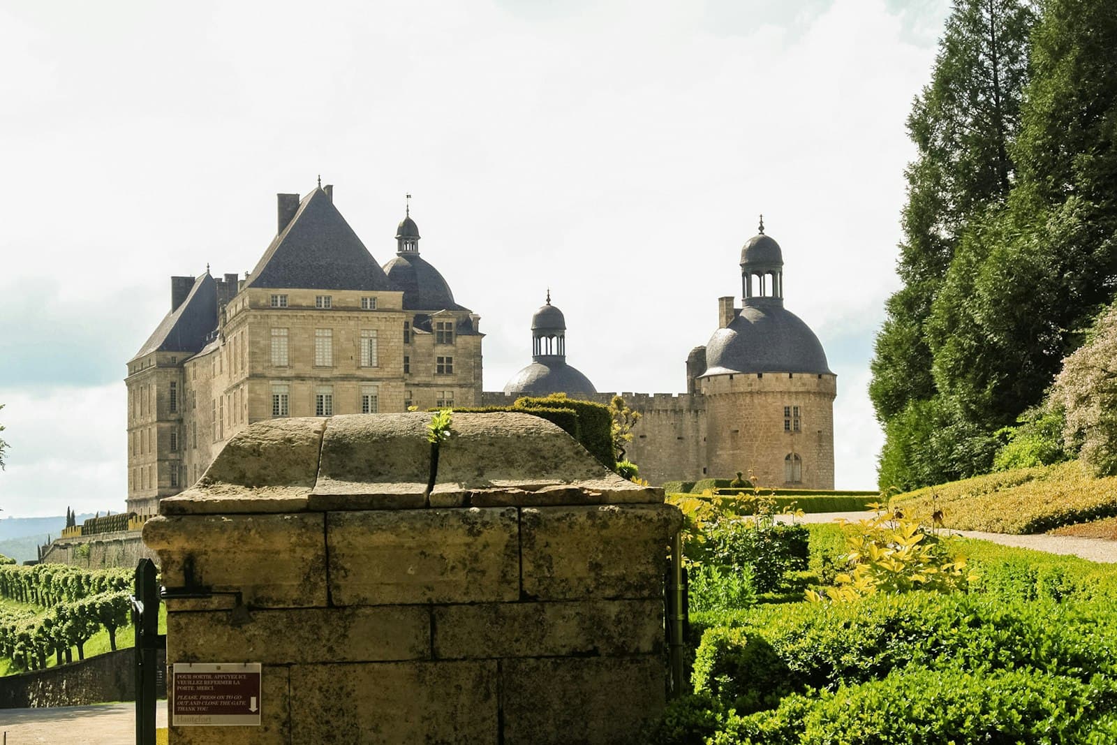 Hautefort — a large building with a clock tower on top of it