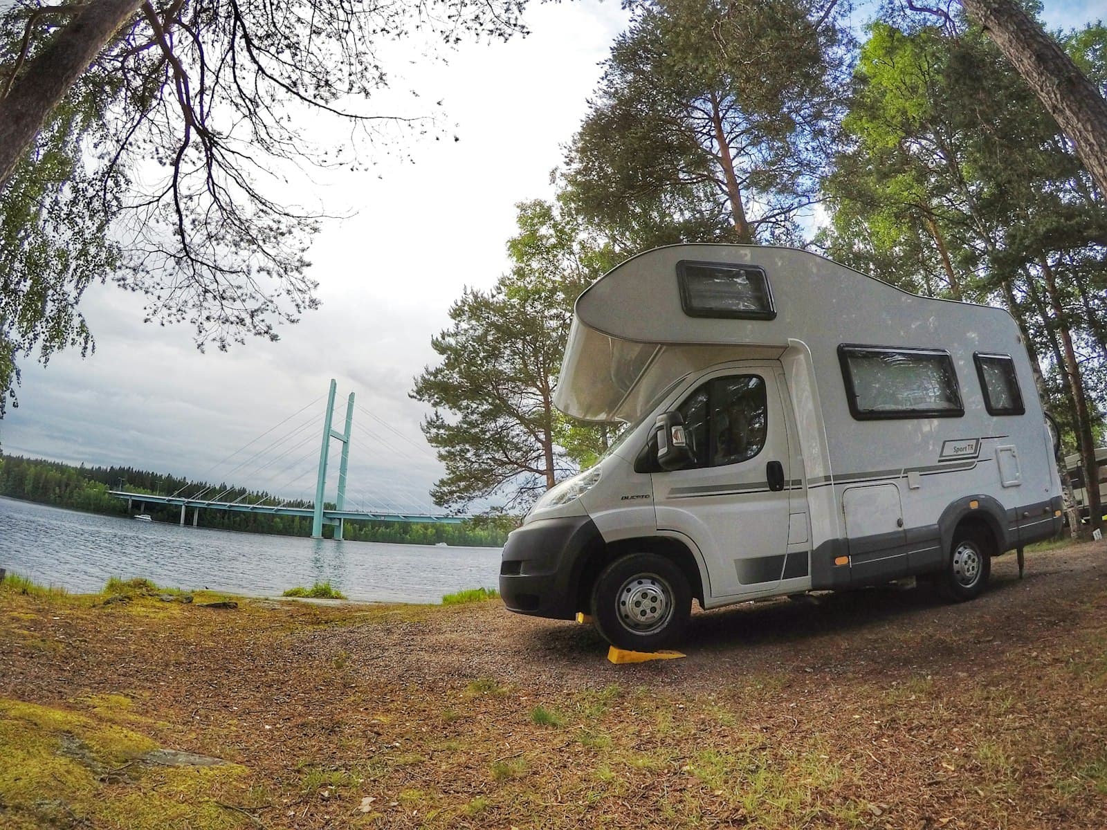 Heinola — white and gray van parked beside green trees during daytime