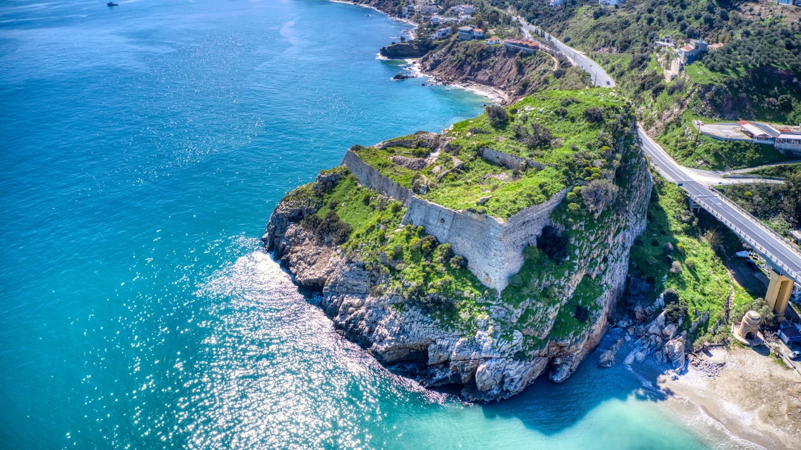 Heraklion — green and brown rock formation beside blue sea during daytime