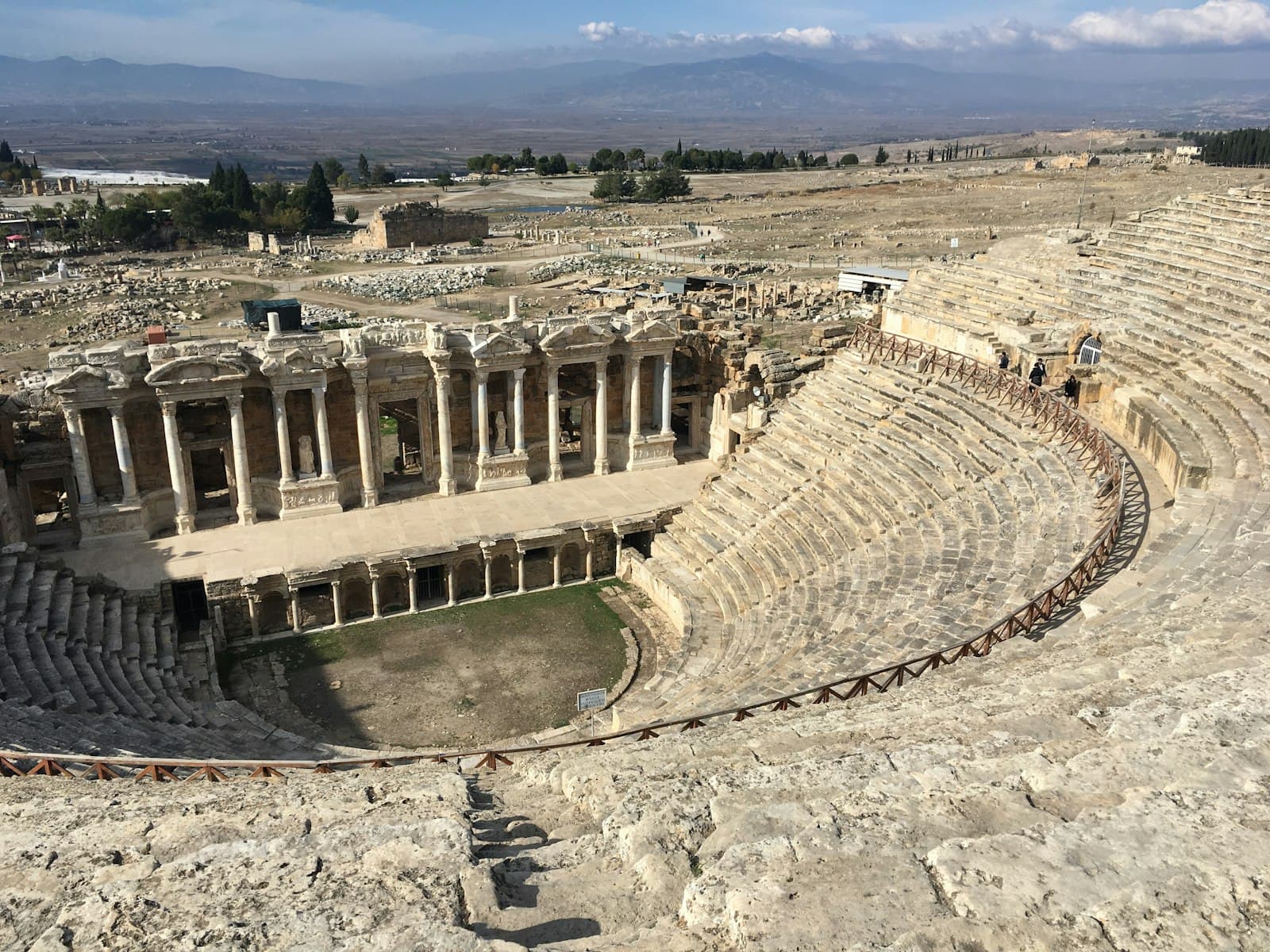 Hierapolis — a roman amphit with people walking around it