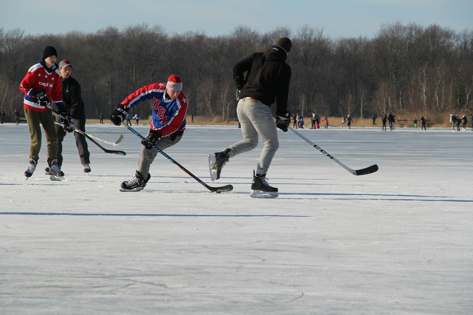 Holland — man in black jacket and white pants riding on red and white ski blades on snow