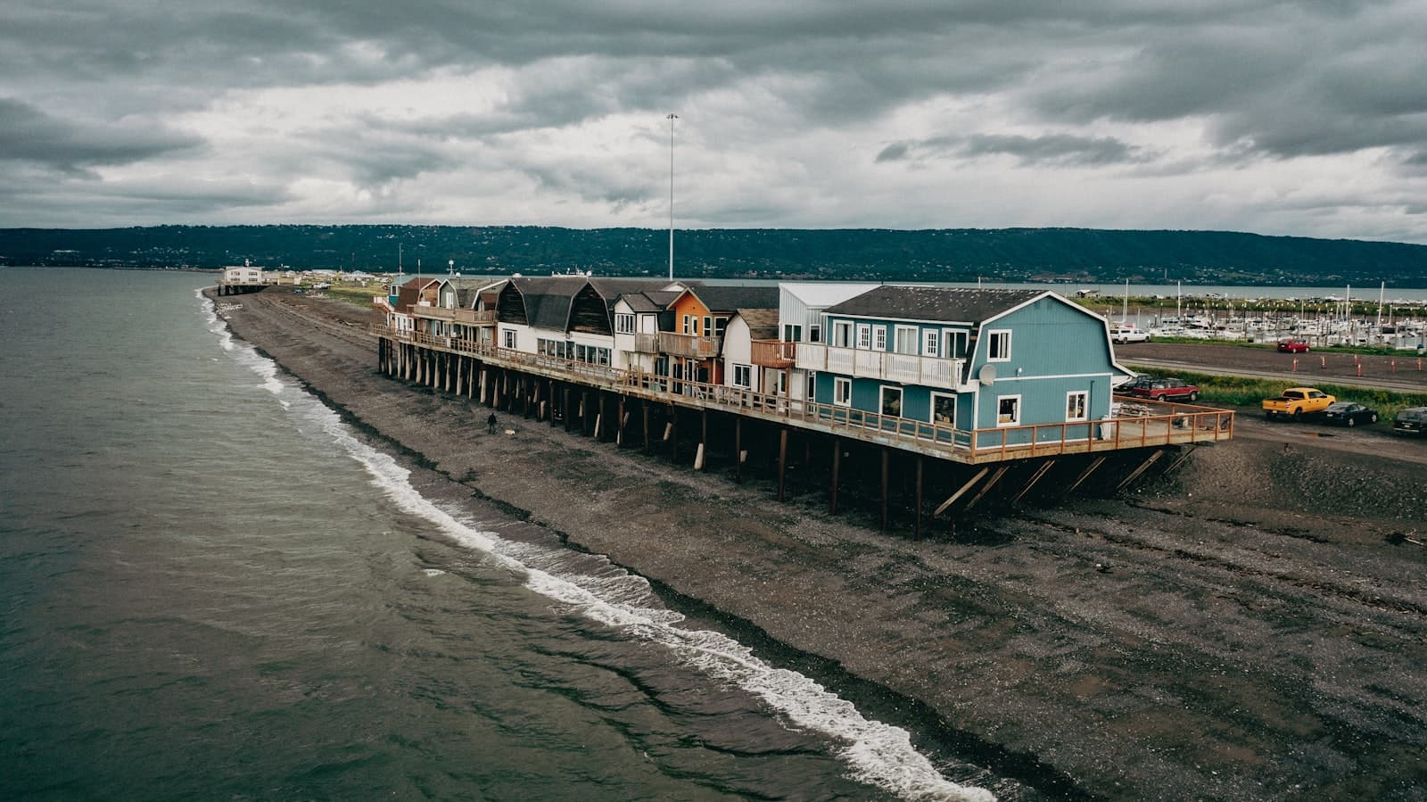 Homer — a pier with houses on top of it on a cloudy day