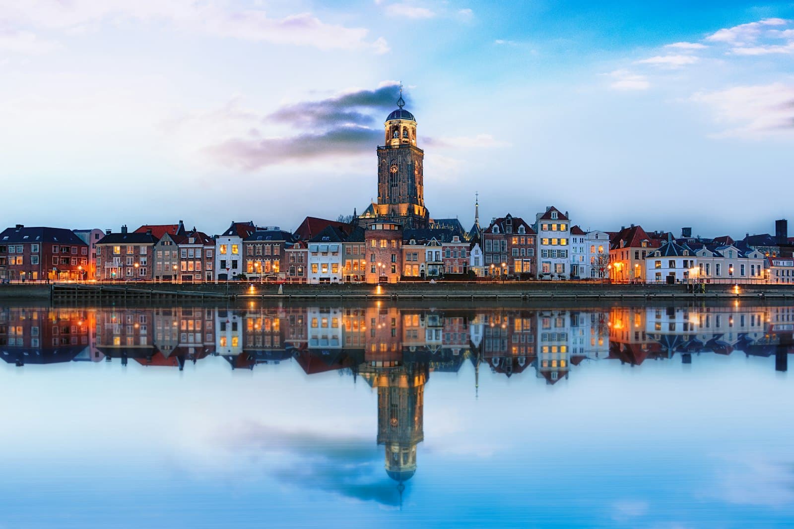 Hoorn — lighted buildings across placid lake