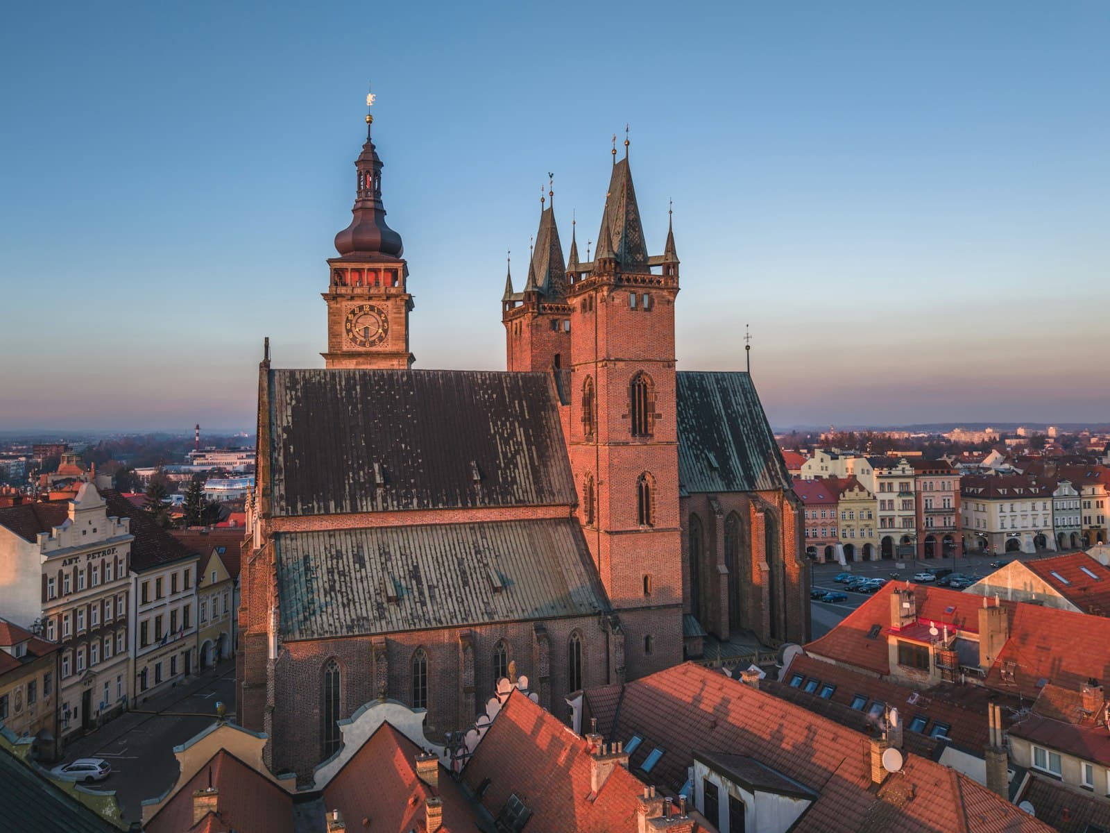 Hradec Králové — Historic church towers over a european town at sunset