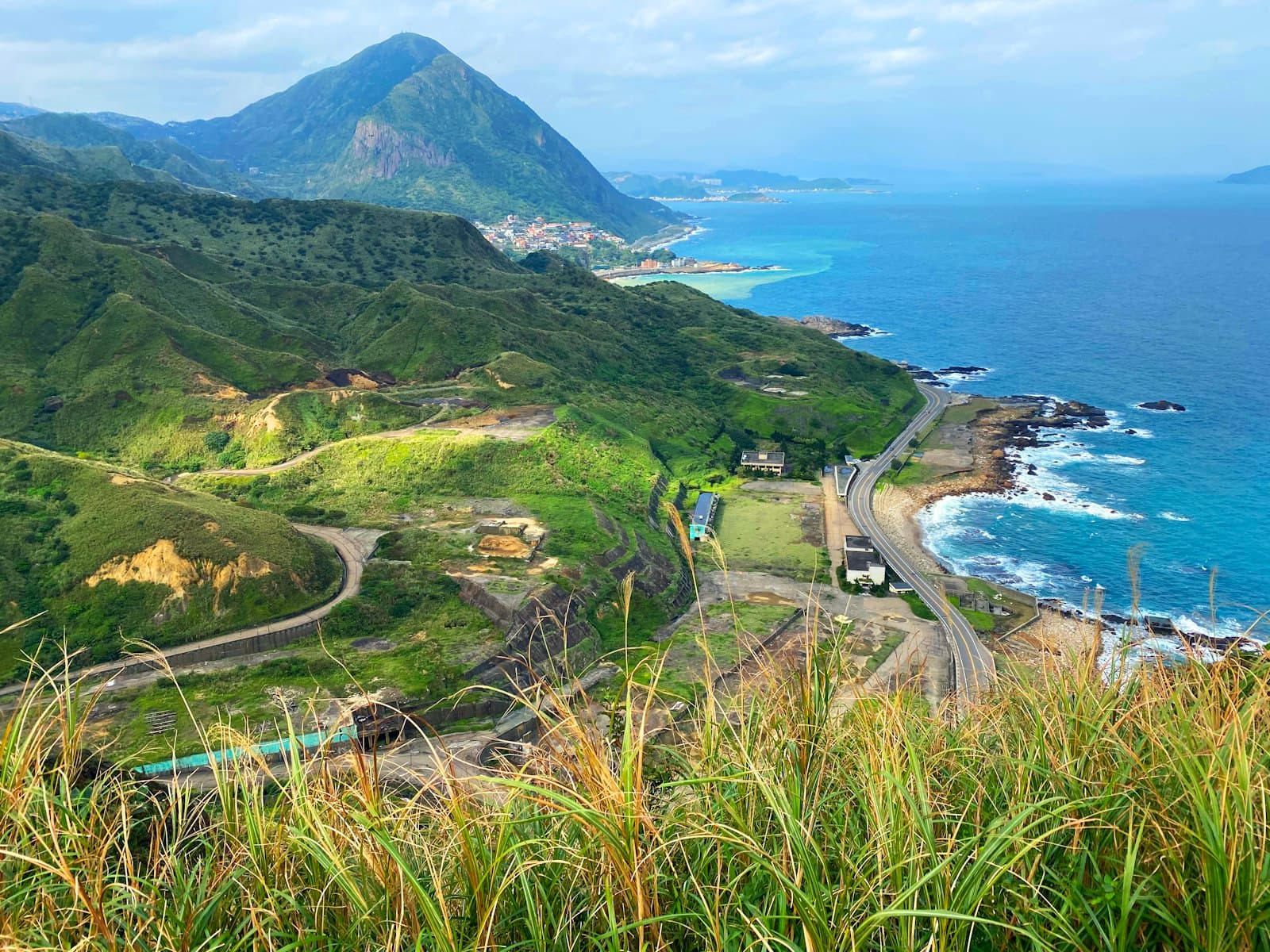 Hualien — green grass field near body of water during daytime