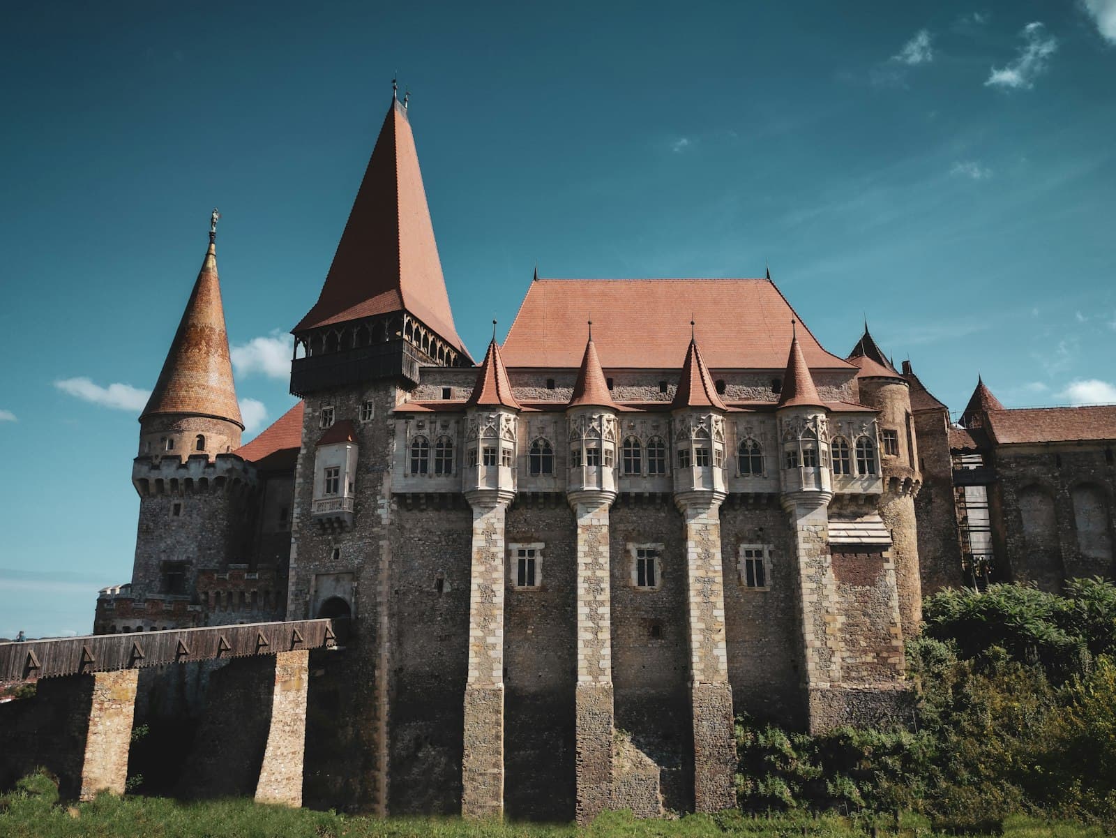 Hunedoara — brown and gray concrete castle under blue sky during daytime