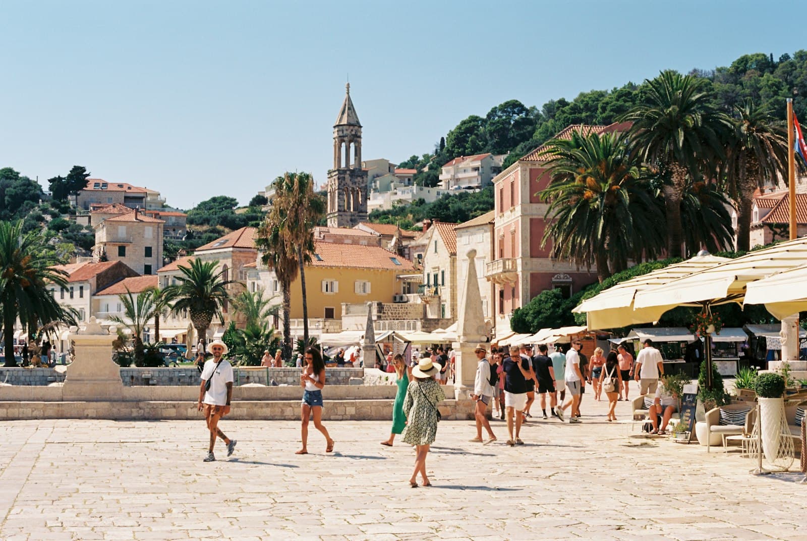 Hvar — a group of people walking around a town square