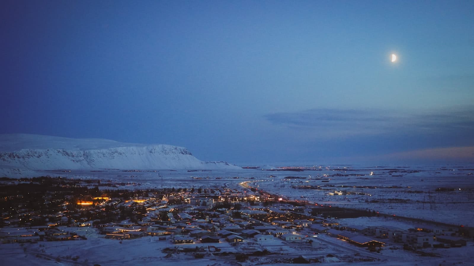 Hveragerði — a snowy landscape with a full moon in the sky