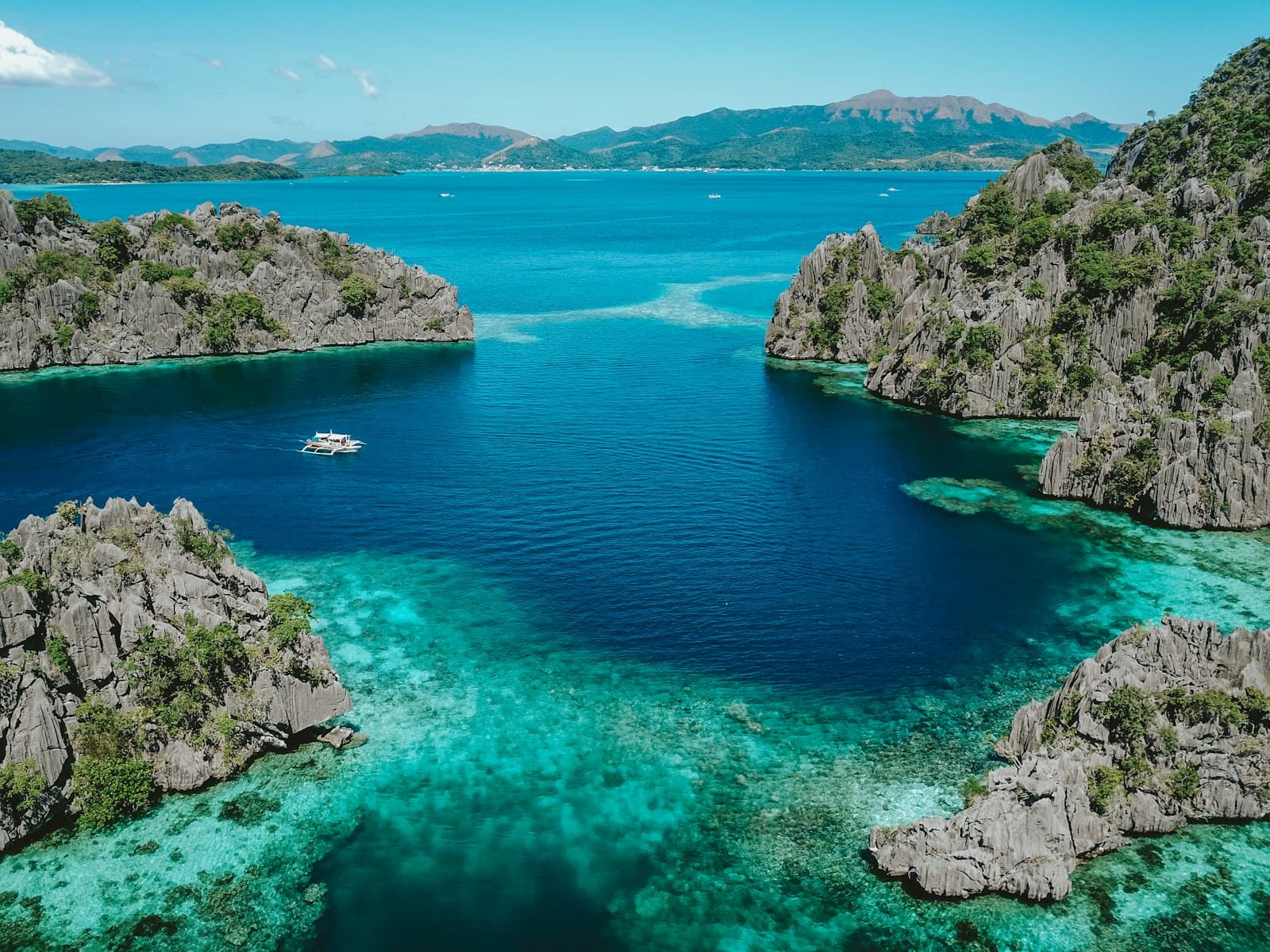 Iloilo — aerial photo of clear blue sea surrounded by mountains